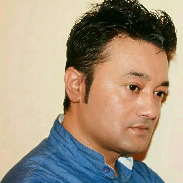 Uttam Pradhan background portrait